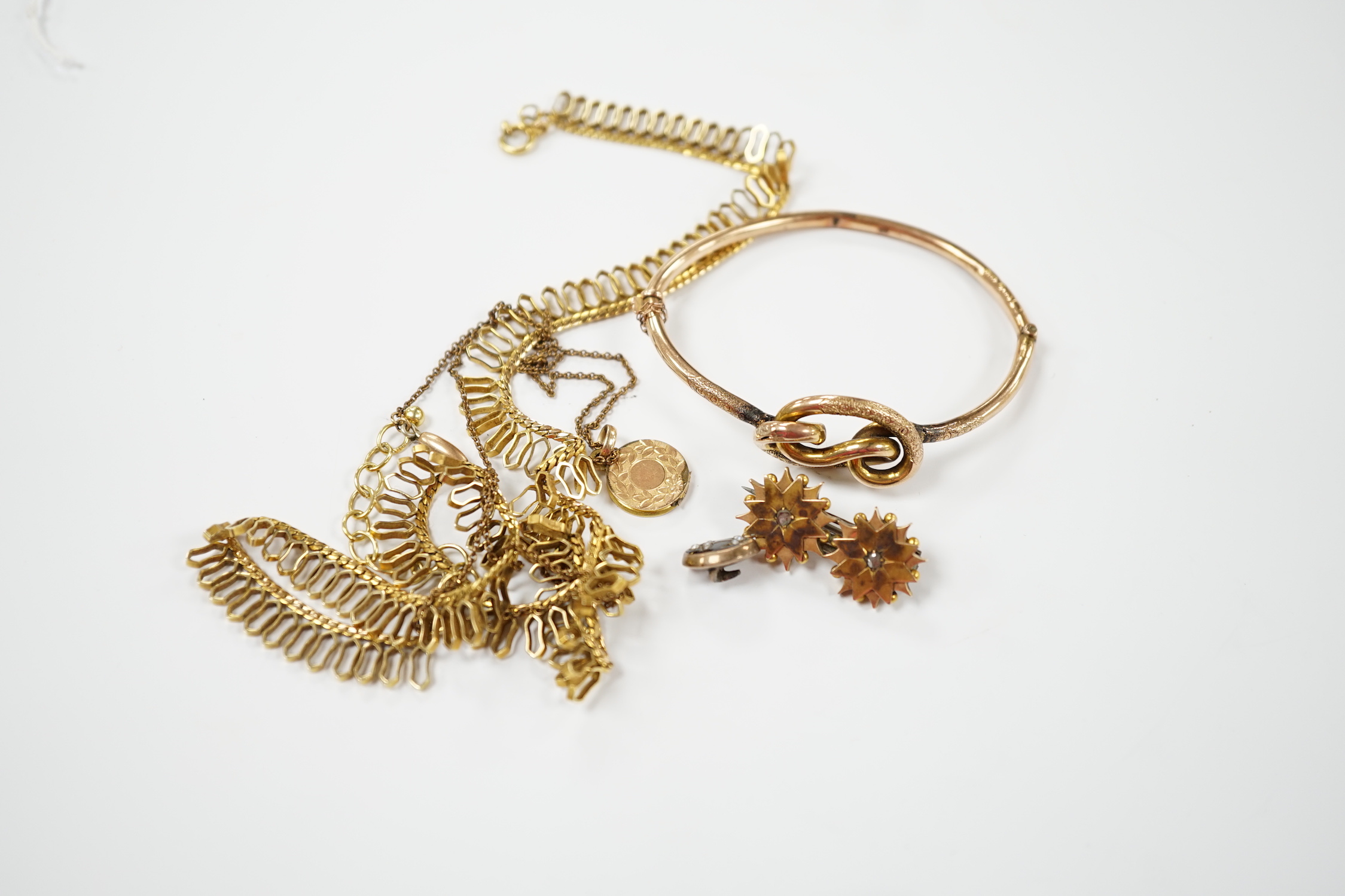 A 9ct. gold fringe necklace, 49cm(a.f.) a 9ct. gold bangle, 25.9 grams, a gold plated locket on a gold plated fine chain, a Victorian yellow metal and two stone diamond set brooch and a stick pin head.